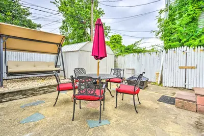 a table with chairs and a pink umbrella at Family-Friendly Keansburg Home Walk to Beach! in Keansburg