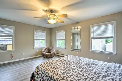 a bedroom with a bed and a ceiling fan at Family-Friendly Keansburg Home Walk to Beach! in Keansburg