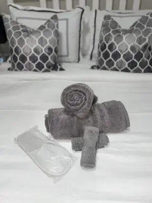 a pile of towels sitting on top of a bed at THE ROOFTOP OASIS in Philadelphia