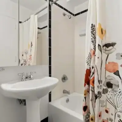 a white bathroom with a sink and a tub at Family Apartment in Excellent Sector of New York in New York