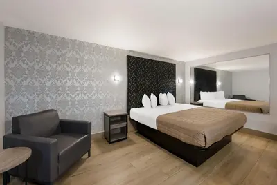 a hotel room with a bed and a chair at Essence Express Wayne in Wayne