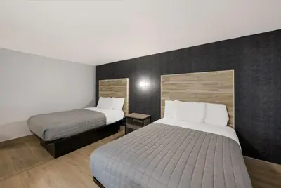 a hotel room with two beds and a bed sidx sidx sidx at Essence Express Wayne in Wayne