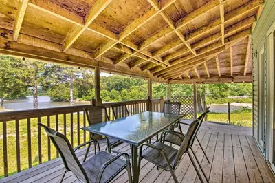 a patio with a table and chairs on a deck at River Views and Covered Deck Susquehanna Home! in Susquehanna