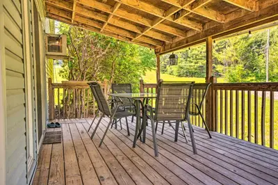 a patio with a table and chairs on a deck at River Views and Covered Deck Susquehanna Home! in Susquehanna