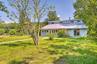 a white house with a tree in the yard at River Views and Covered Deck Susquehanna Home! in Susquehanna
