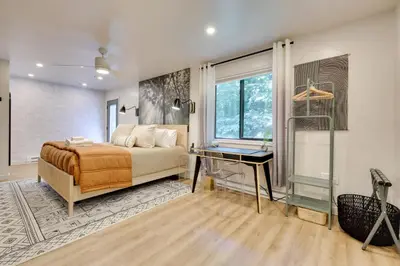 a bedroom with a bed and a desk and a window at Sweetfern Gouldsboro Cabin Deck and Lake Access in Gouldsboro