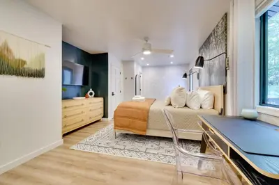 a bedroom with a bed and a desk in it at Sweetfern Gouldsboro Cabin Deck and Lake Access in Gouldsboro