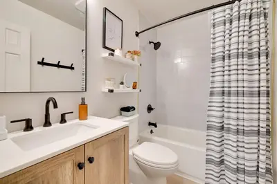 a bathroom with a sink and a toilet and a shower at Sweetfern Gouldsboro Cabin Deck and Lake Access in Gouldsboro