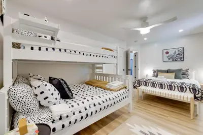 a bedroom with two beds and a bunk bed at Sweetfern Gouldsboro Cabin Deck and Lake Access in Gouldsboro