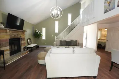 a living room with a white couch and a fireplace at ADA-accessible, newly remodeled 3-BR/2-Bath Home in Tobyhanna