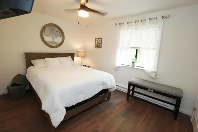 a bedroom with a bed and a ceiling fan at ADA-accessible, newly remodeled 3-BR/2-Bath Home in Tobyhanna