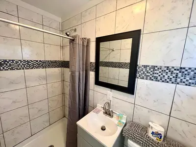 a bathroom with a sink and a toilet and a mirror at Cobmin Ridge Motel in Branchville