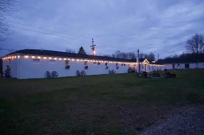 a large white building with lights on it at night at Cobmin Ridge Motel in Branchville