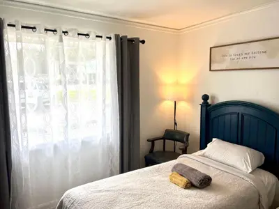 a bedroom with a bed with a teddy bear on it at Cobmin Ridge Motel in Branchville