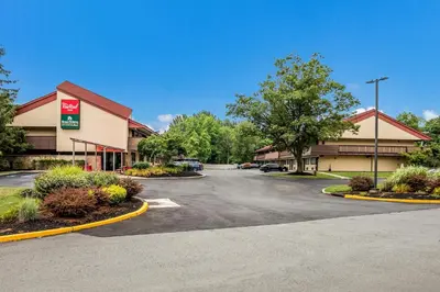 a parking lot in front of a hotel at HomeTowne Studios by Red Roof Princeton - Ewing/ Lawrenceville in Trenton