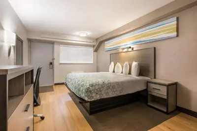 a hotel room with a bed and a kitchen at HomeTowne Studios by Red Roof Princeton - Ewing/ Lawrenceville in Trenton