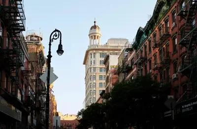 a city street with tall buildings and a street light at Nine Orchard in New York