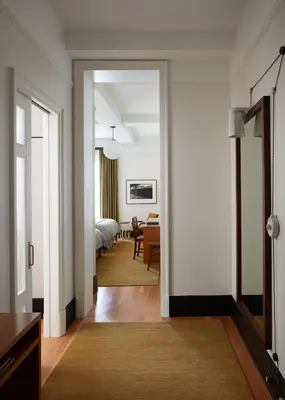 a hallway with a room with a bed and a dining room at Nine Orchard in New York