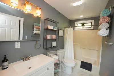a bathroom with a sink and a toilet and a mirror at A gorgeous home, 5BR-2BT, perfect for your family! in Tobyhanna