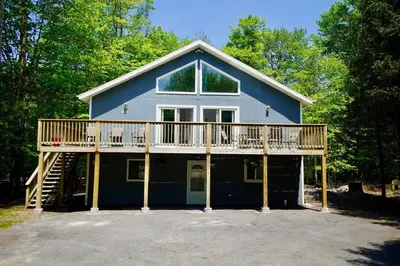a large house with a large deck on top of it at A gorgeous home, 5BR-2BT, perfect for your family! in Tobyhanna