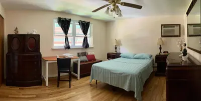 a bedroom with a bed and a desk and a table at ABnB Superhost - Siri's Favorite Place in Havertown
