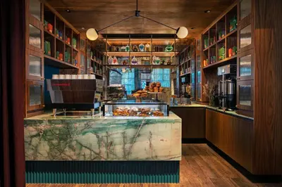 a restaurant with a counter with food on it at Moxy NYC Lower East Side in New York