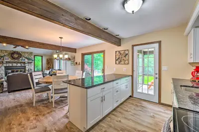 an open kitchen and dining room with a dining table at Near Hiking and Skiing Albrightsville Home with Deck! in Albrightsville