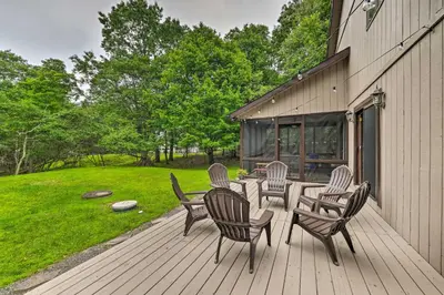 a wooden deck with four chairs and a table at Near Hiking and Skiing Albrightsville Home with Deck! in Albrightsville