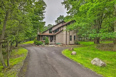 a house on a dirt road in the woods at Near Hiking and Skiing Albrightsville Home with Deck! in Albrightsville
