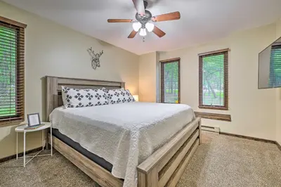 a bedroom with a bed and a ceiling fan at Near Hiking and Skiing Albrightsville Home with Deck! in Albrightsville