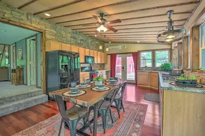 a kitchen with a table and chairs in a room at Poconos Cottage with Fire Pit Near Lake Harmony in Albrightsville