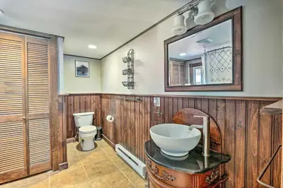 a bathroom with a sink and a toilet at Poconos Cottage with Fire Pit Near Lake Harmony in Albrightsville