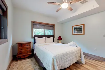 a bedroom with a bed and a ceiling fan at Harmony House in Lake Harmony