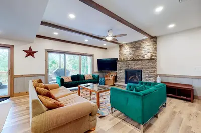 a living room with two couches and a fireplace at Harmony House in Lake Harmony