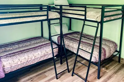 two bunk beds are in a room with a floor at Harmony House in Lake Harmony