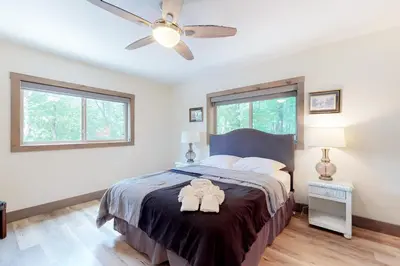 a bedroom with a bed and a ceiling fan at Harmony House in Lake Harmony