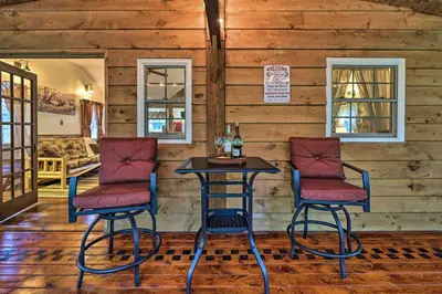 a table and two chairs in a room at Cabin with Trails and Creek! 23 Mi to Camelback Slopes in Greentown