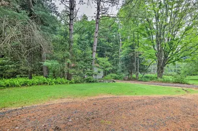 a dirt road in a park with trees and a house at Cabin with Trails and Creek! 23 Mi to Camelback Slopes in Greentown