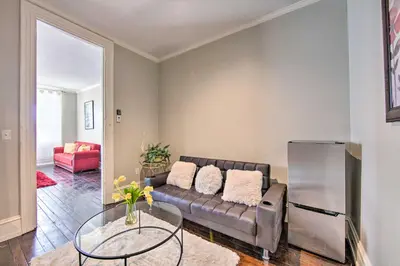 a living room with a couch and a glass table at 1 Mi to Dtwn Historic Harrisburg Home in Harrisburg