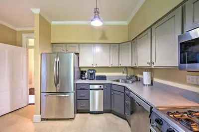 a kitchen with white cabinets and a stainless steel refrigerator at 1 Mi to Dtwn Historic Harrisburg Home in Harrisburg