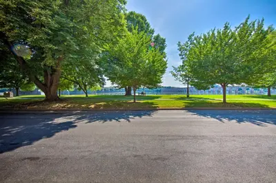 an empty parking lot with trees in a park at 1 Mi to Dtwn Historic Harrisburg Home in Harrisburg