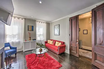 a living room with a red couch and a red rug at 1 Mi to Dtwn Historic Harrisburg Home in Harrisburg