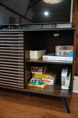 a book shelf with a tv and some books at The Loft at Woodhaven Hideaway in Myerstown