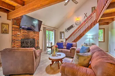 a living room with leather furniture and a fireplace at Bushkill House with Deck and Community Amenities! in Bushkill