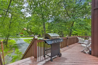 a grill on a wooden deck with a view of a park at Bushkill House with Deck and Community Amenities! in Bushkill