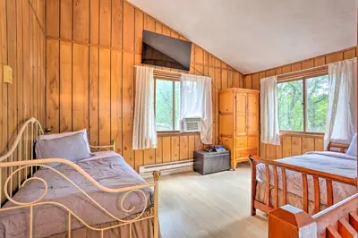 a bedroom with two beds and wooden walls at Bushkill House with Deck and Community Amenities! in Bushkill