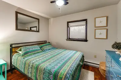 a bedroom with a bed and a mirror on the wall at Mtn-View Gem with Deck and Hot Tub in Tannersville in Tannersville