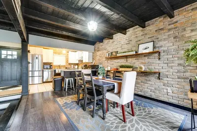 a kitchen and dining room with a brick wall at Mtn-View Gem with Deck and Hot Tub in Tannersville in Tannersville