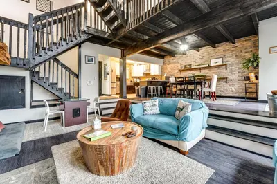 a living room with a blue couch and a table at Mtn-View Gem with Deck and Hot Tub in Tannersville in Tannersville