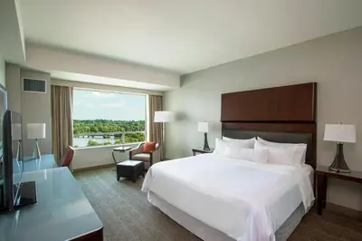 a hotel room with a bed and a large window at The Westin Wilmington in Wilmington